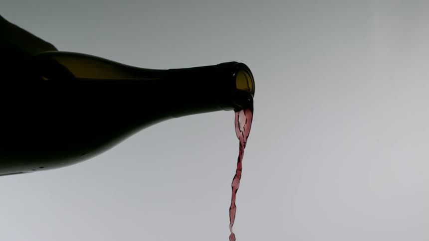 Slow motion of wine being poured from a wine bottle
