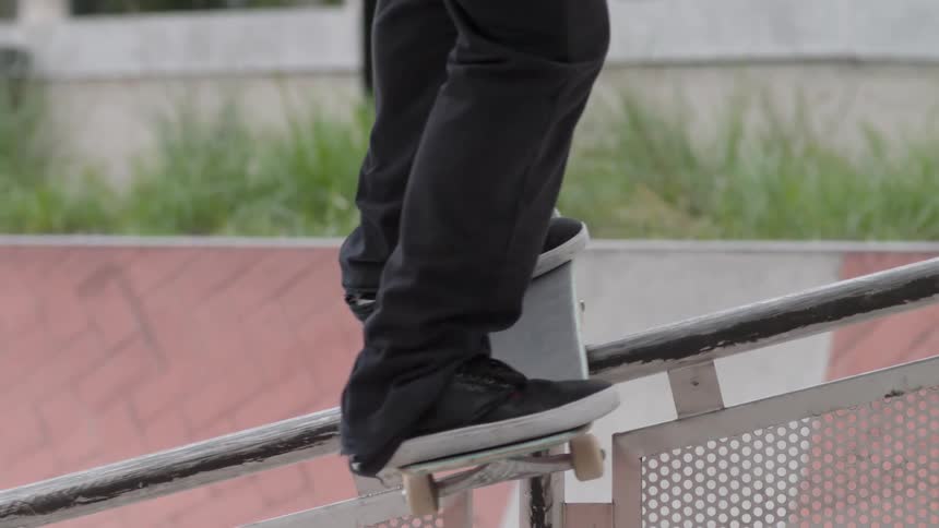 Skateboarder descending a handrail