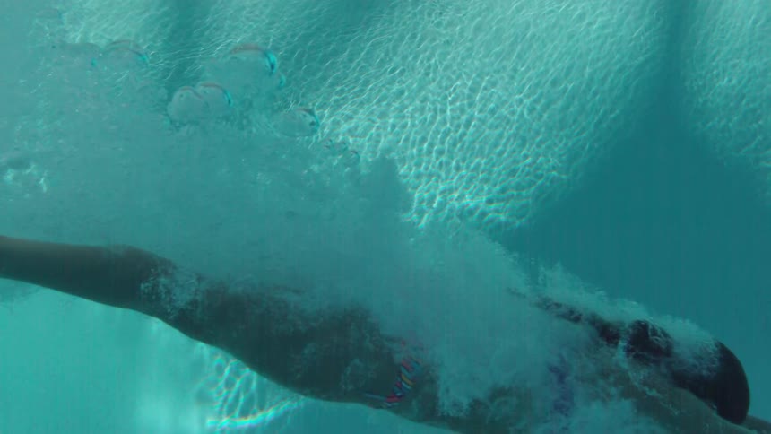 A woman diving into a swimming pool