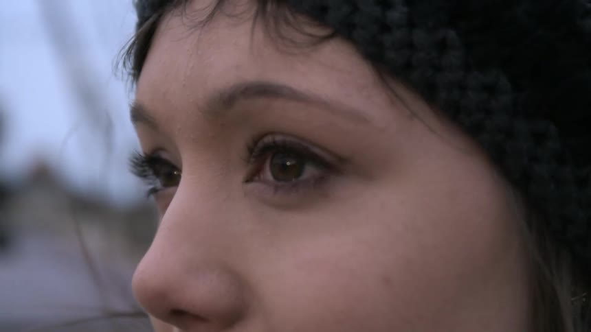 Wind blowing a woman's hair around her face