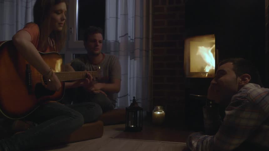 A group of people sitting y a fireplace