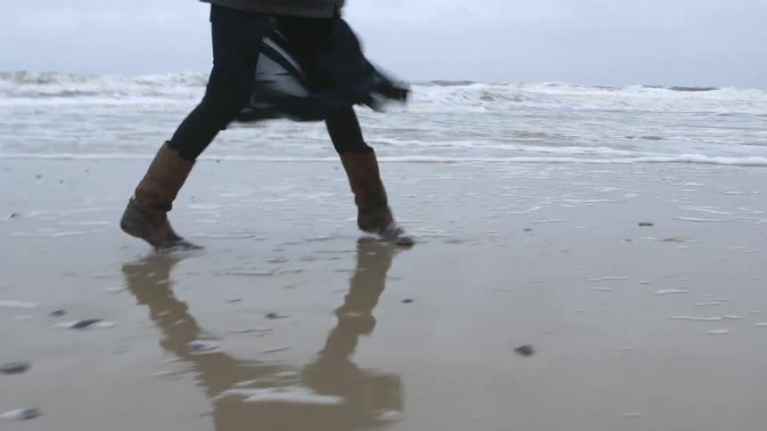 Woman skipping on the beach