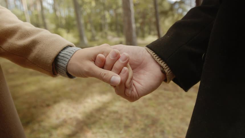 Expecting Couple Walking In The Forest