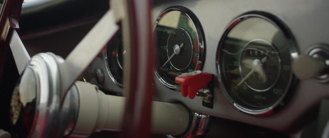 Close view of the steering wheel and dashboard of an old classic vehicle
