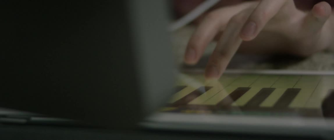 A person is playing a keyboard on a digital display