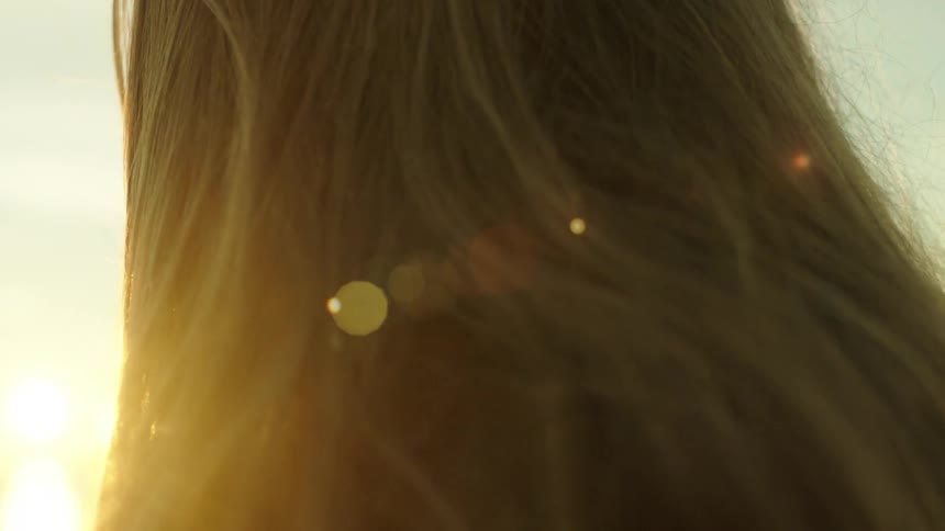 Woman looking out towards the sun