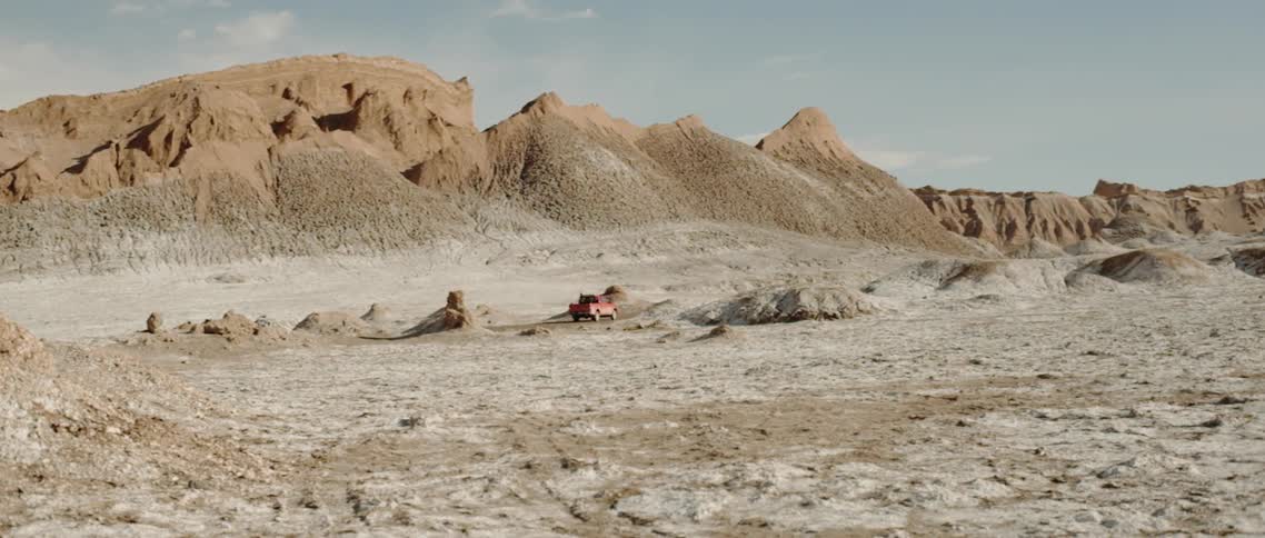 A truck drives in the desert