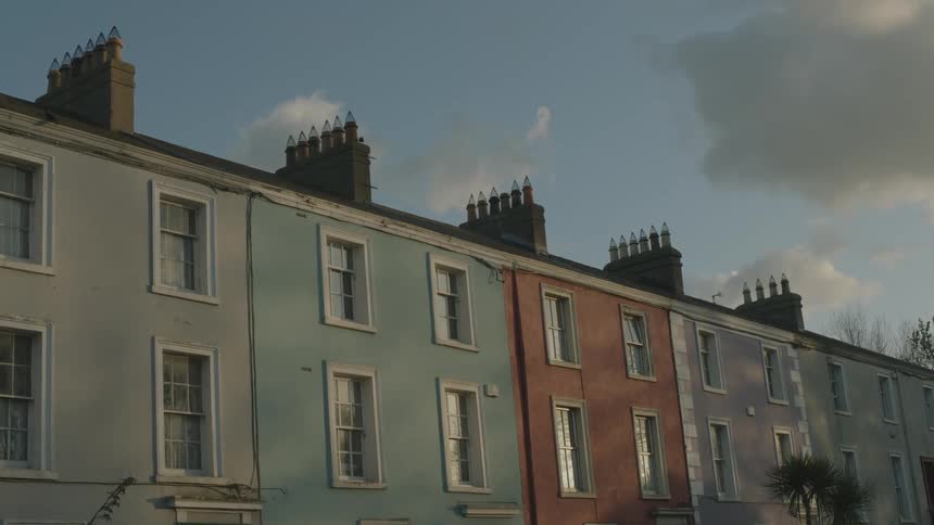 A row of homes are connected on a street