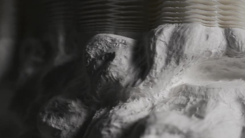 A white object is forming slowly before completing