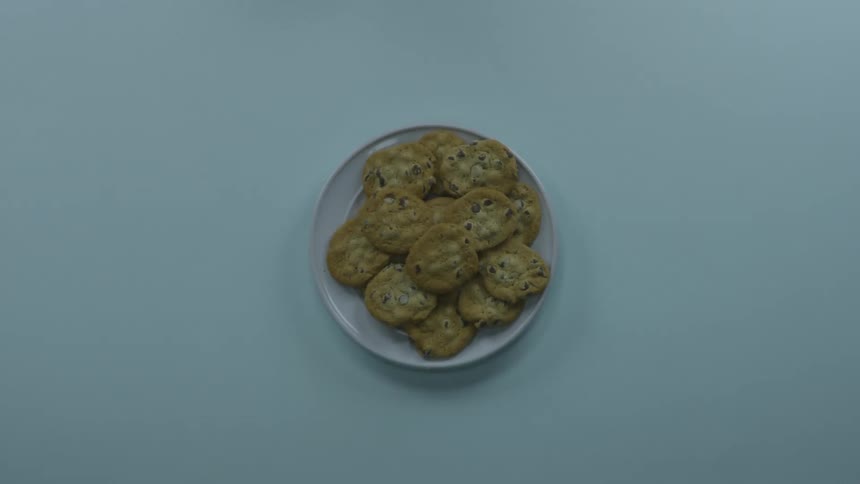 A person slapping another person's hand away from the cookies