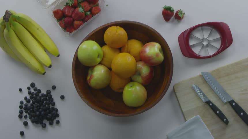 A person grabbing an apple and then showing a bite in it