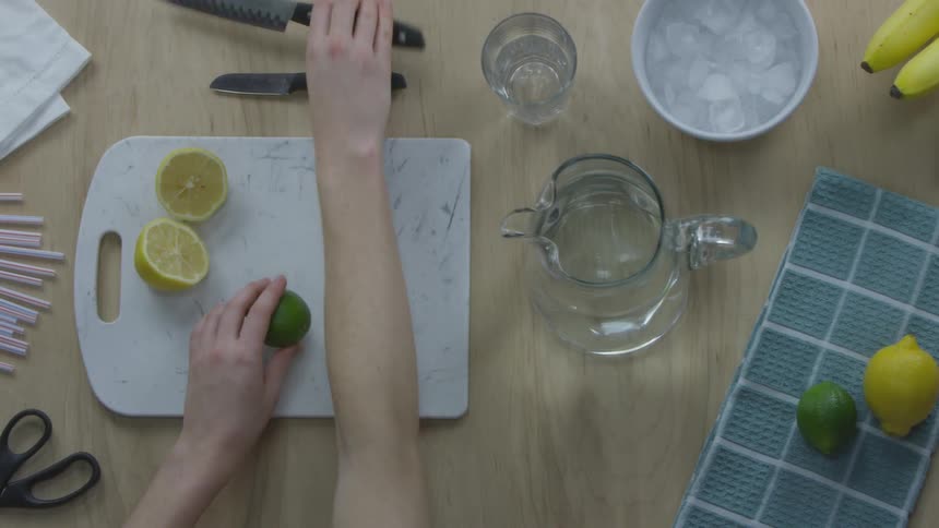Person cutting a lime on a cutting board