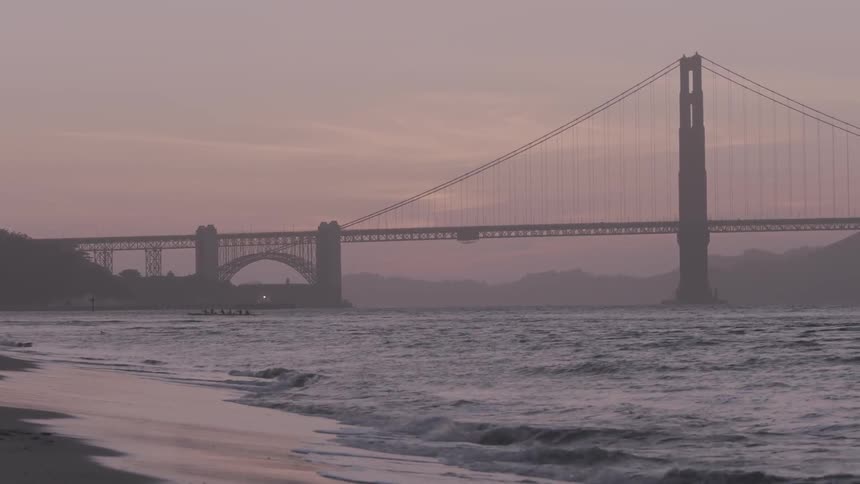 Ocean waves wash ashore at sunset