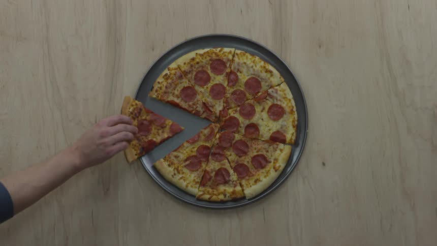 A person grabbing a slice of pepperoni pizza off a tray