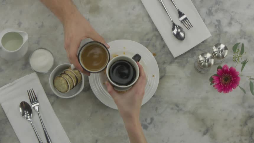 Couple eating breakfast and drinking coffee