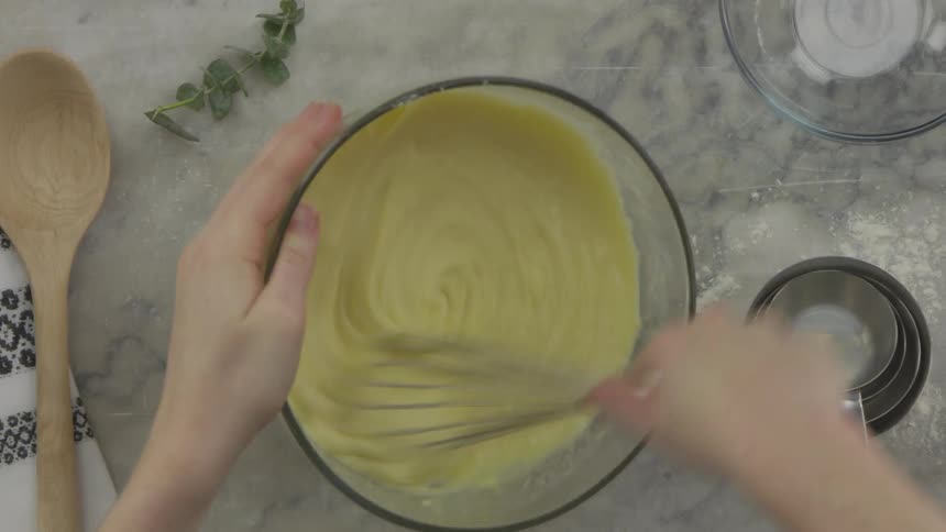 Batter is mixed in a glass bowl with a metal whisk