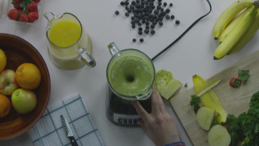 Person turns on a blender with a smoothie in it and some flies out