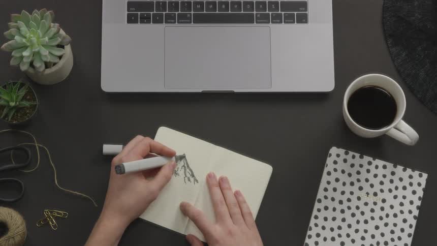 A person is drawing on a piece of paper
