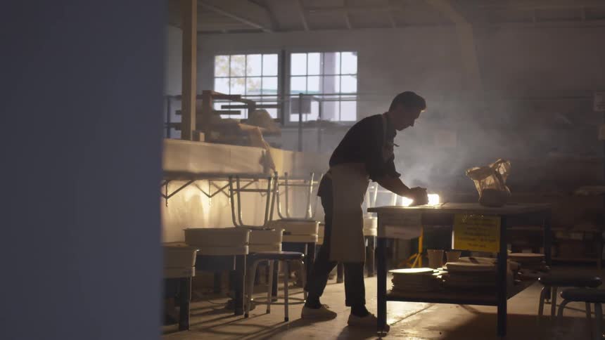 Man works on item in workshop