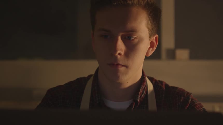 A caucasian male is looking at something