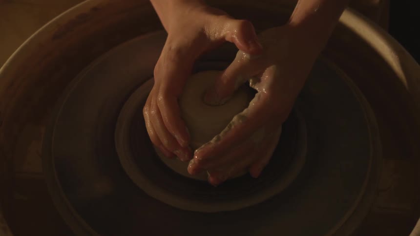 A person molding clay