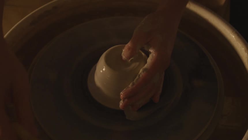 Person turning pottery on a wheel