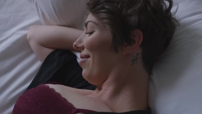A woman is laying on a bed