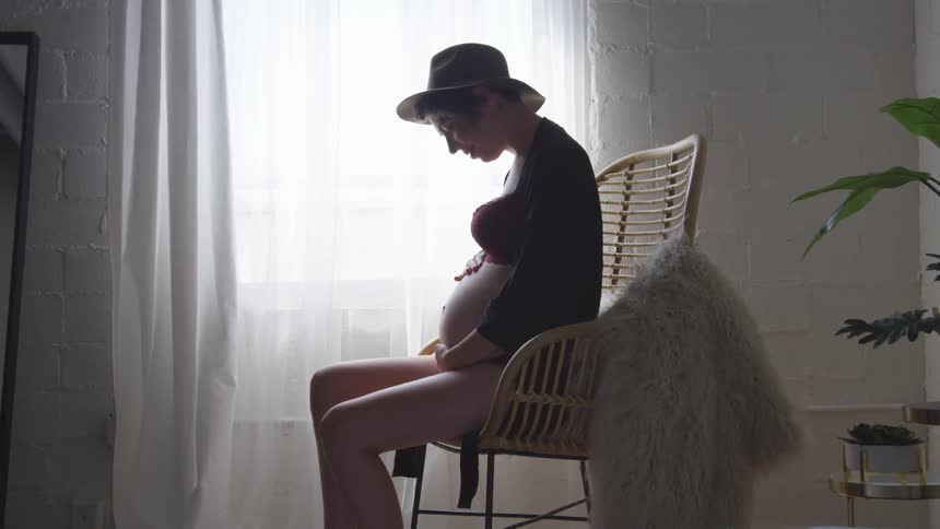 A woman holding her pregnant belly