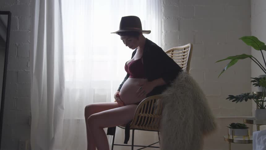 A pregnant woman holding her stomach