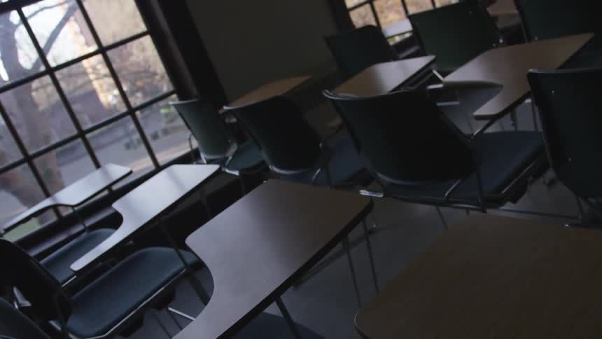 An empty classroom with a view to the campus on a fall day