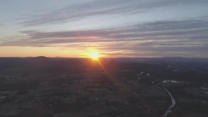 Flying over a rural community at sunset