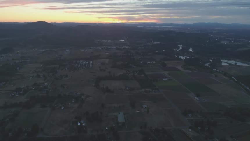 Flying over a rural area at sunset
