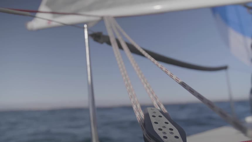 Pulley holds rope holding up sail on a boat