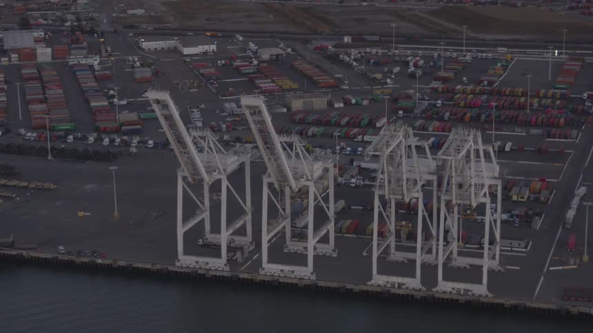 A flying overview of a cargo loading dock next to water