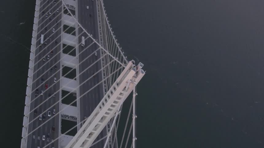 Cars are driving on a bridge over the ocean