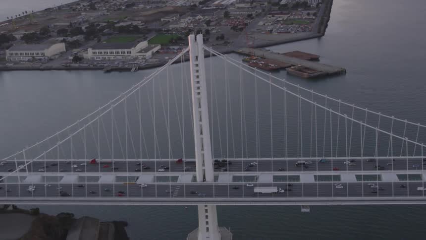 Traffic crosses suspension bridge in city