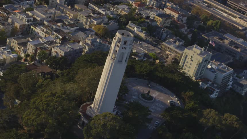Circling a tower in the middle of a park in a city