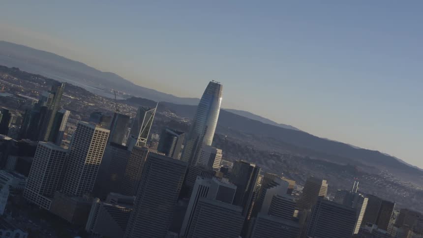 Aerial shot of city skyline with mountains in background