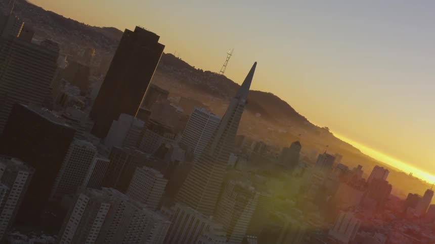 Transamerica building against the chicago skyline at sunset