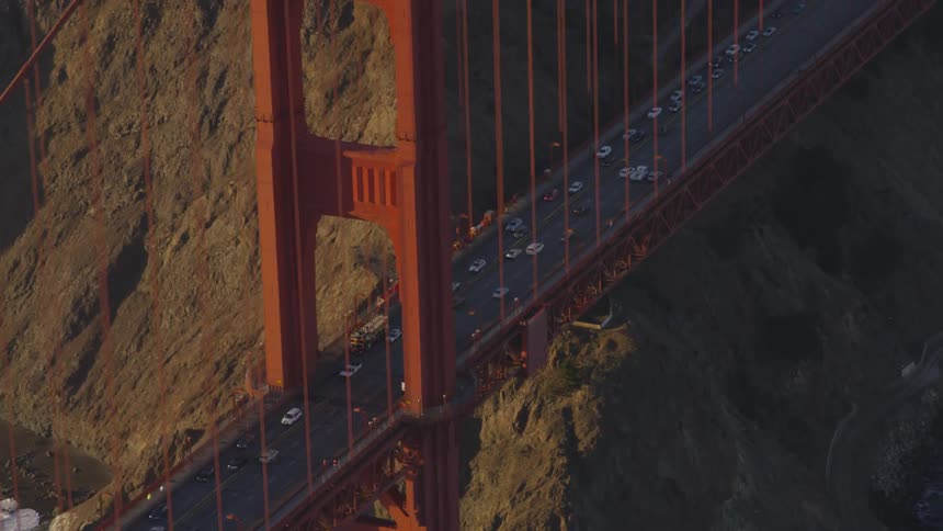 Cars travel over the golden gate bridge