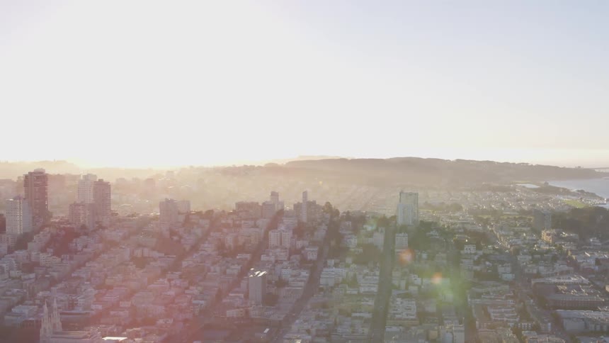 The skyline of the city next to the sea while the sun goes down