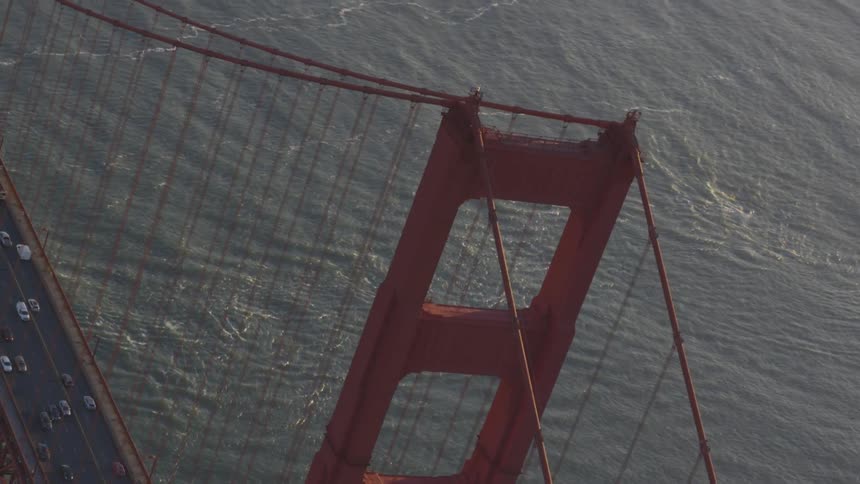 The golden gate suspension bridge carries traffic over calm waters