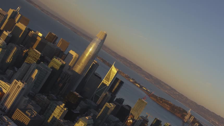 Flying over a city next to a body of water