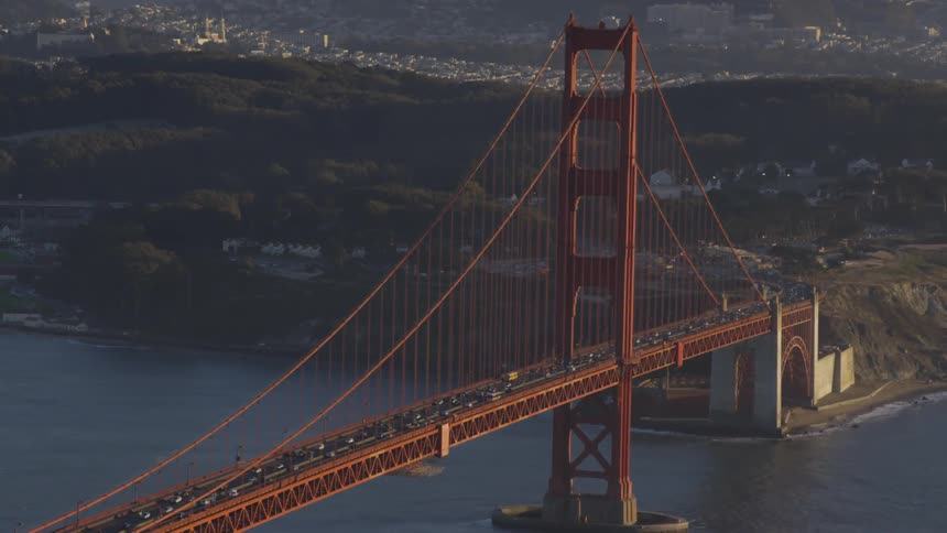 An aerial view of traffic flowing on the golden gate bridge