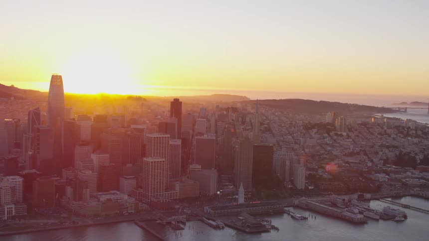 Skyline of the city next to the sea while the sun goes down