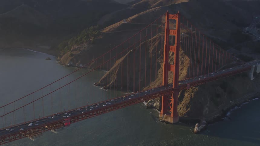 Cars travel over the golden gate bridge