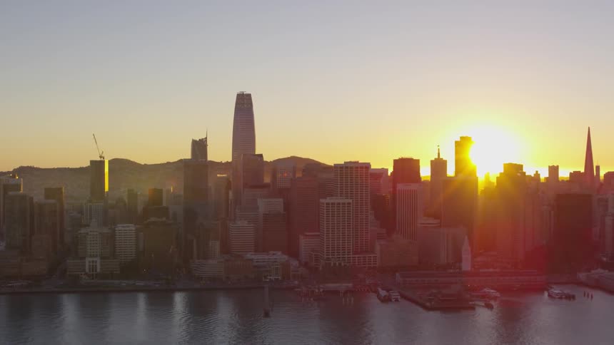 Sun setting behind the buildings in the city near the marina