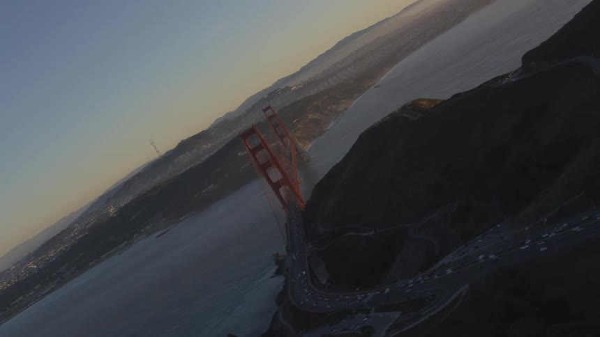 Cars crossing the golden gate bridge at dusk