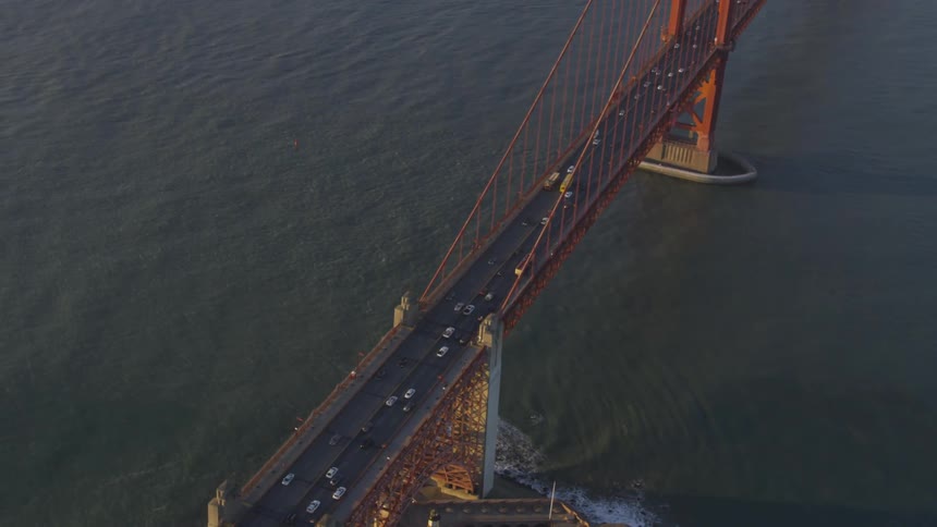 Cars are driving on a bridge over the ocean