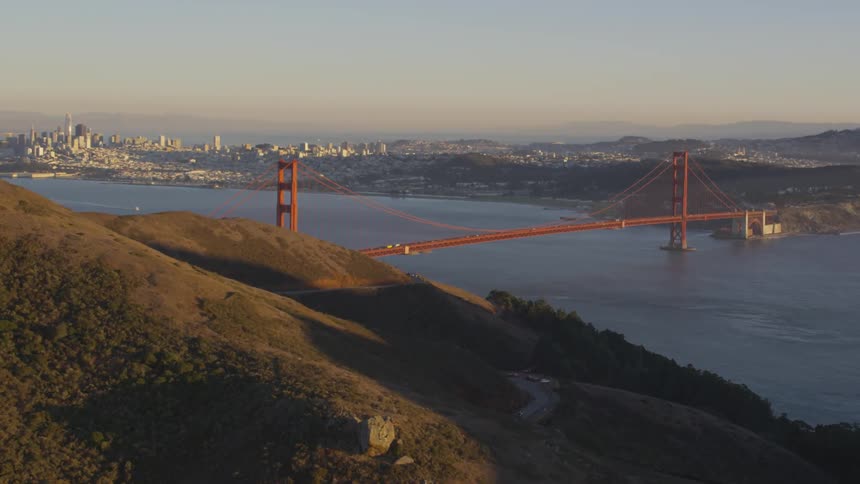 The golden gate bridge and city skyline across the strait of water